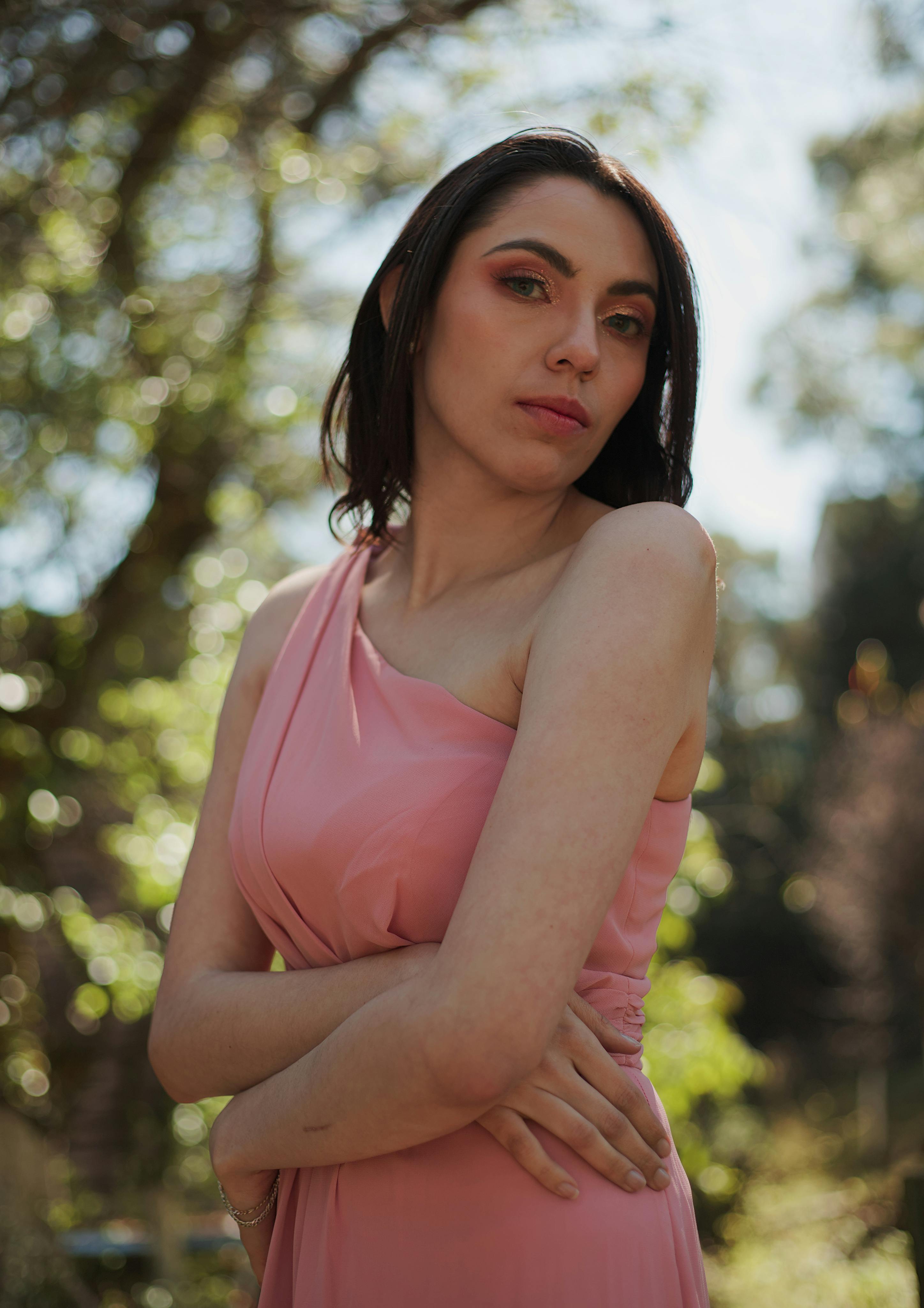 A woman wearing a pink bridesmaid dress